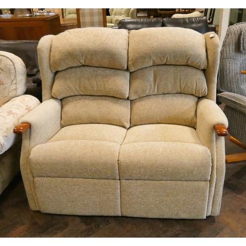 203 - A small two seater wing back settee in fawn mottled covering