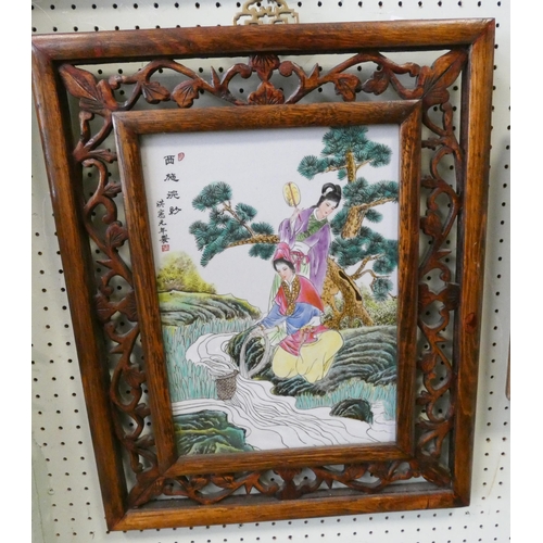 251 - A Japanese porcelain plaque in pierced hardwood frame, measurement overall 20