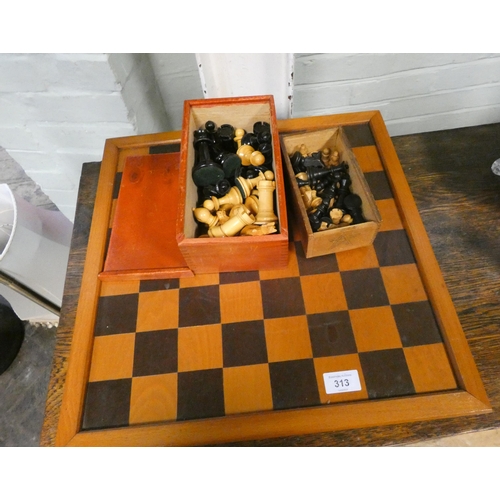 313 - A chessboard with two sets of chess pieces, large glass powder bowl, candlesticks and magazine rack