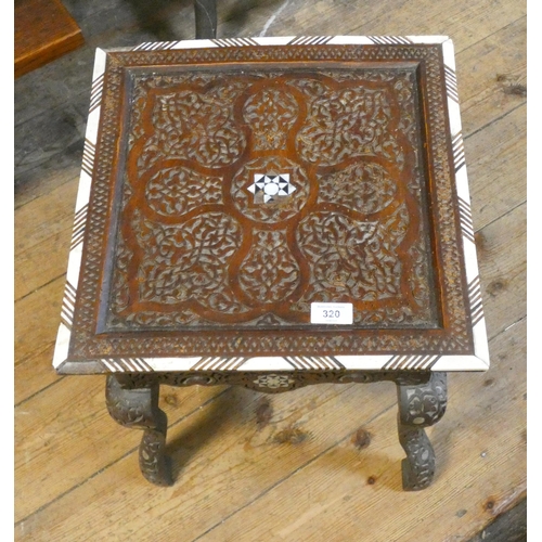 320 - A Moorish style carved and mother of pearl inlaid low square occasional table, fitted drawer