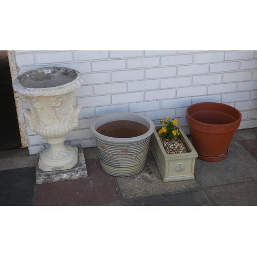 711 - An urn shaped reconstituted concrete planter and three various other garden pots