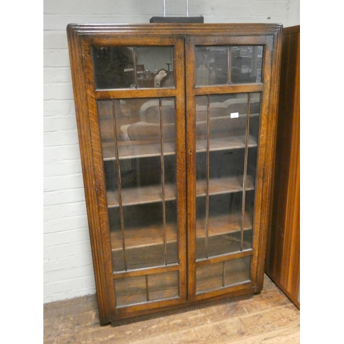 94 - An oak two door glazed bookcase, 3' wide