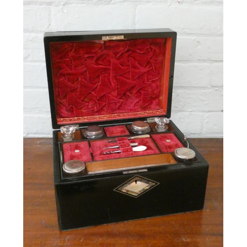 365 - A Victorian ladies travel case in ebony case with mother of pearl inlay with interior fitted trays a... 