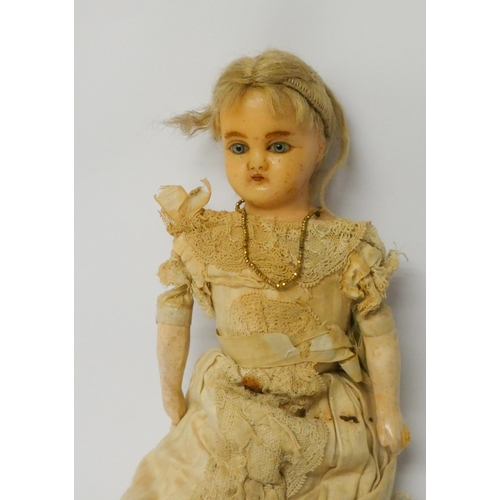 337 - A Victorian waxed head doll with fabric body and composition arms and legs