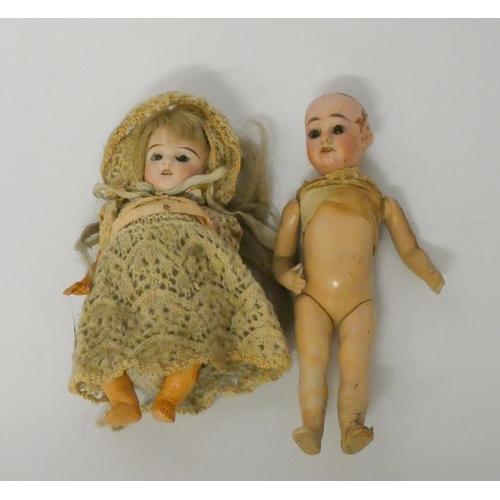 338 - Two miniature bisque head dolls - one has a small crack