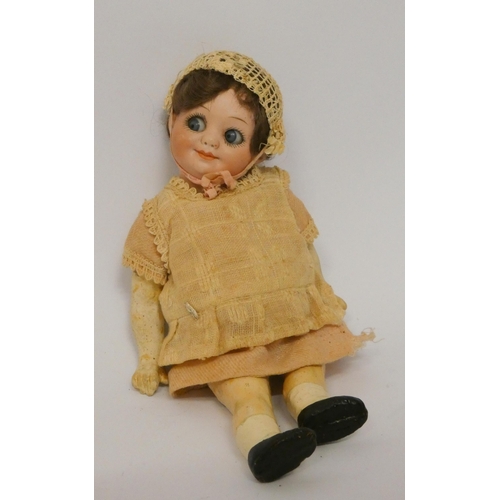 339 - An Armand Marseille flirty eyed bisque head doll with composition body, head numbered 323 A11 O.M