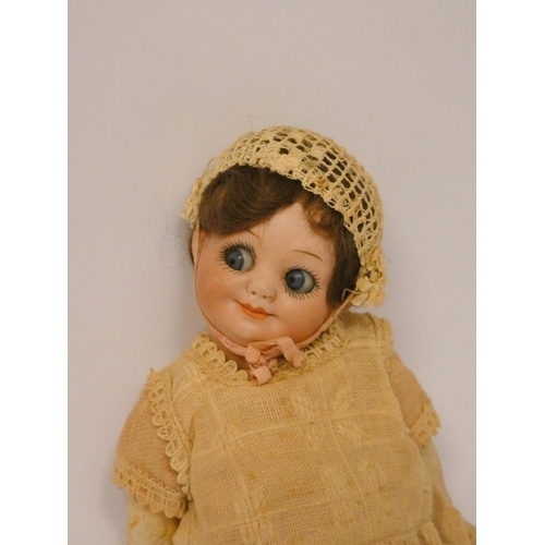 339 - An Armand Marseille flirty eyed bisque head doll with composition body, head numbered 323 A11 O.M