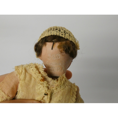 339 - An Armand Marseille flirty eyed bisque head doll with composition body, head numbered 323 A11 O.M