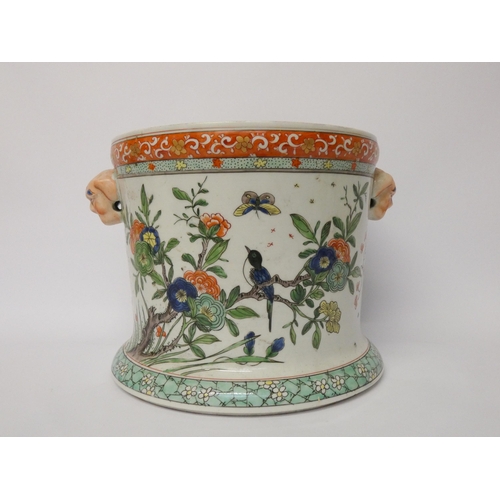 350 - A Japanese porcelain twin handled jardinière with unusual mask handles, 18cms high