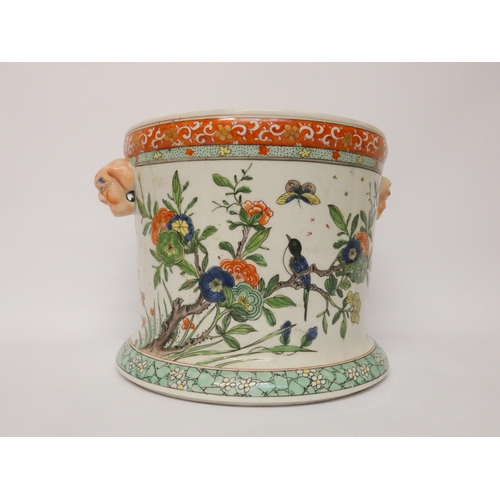 350 - A Japanese porcelain twin handled jardinière with unusual mask handles, 18cms high