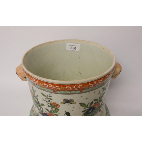 350 - A Japanese porcelain twin handled jardinière with unusual mask handles, 18cms high