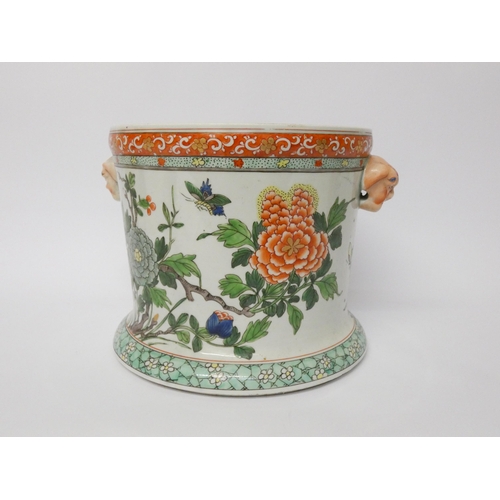 350 - A Japanese porcelain twin handled jardinière with unusual mask handles, 18cms high