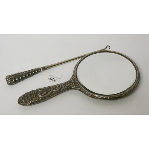 442 - A silver backed dressing table mirror and a button hook