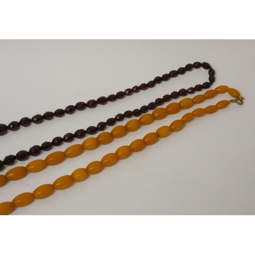 471 - A long vintage row of faceted cherry amber beads and another row of amber beads.