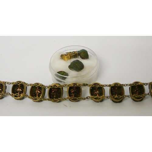 478 - An antique Scarab set bracelet in yellow metal.