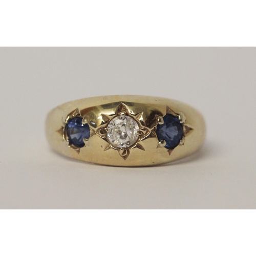 517 - A 9ct yellow gold sapphire and CZ three stone gypsy ring, size U, 4.5gms