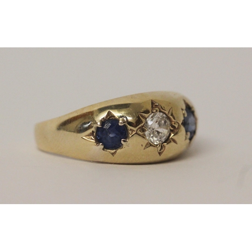 517 - A 9ct yellow gold sapphire and CZ three stone gypsy ring, size U, 4.5gms