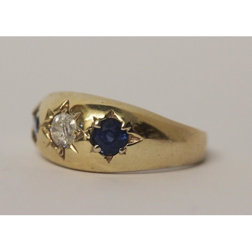 517 - A 9ct yellow gold sapphire and CZ three stone gypsy ring, size U, 4.5gms