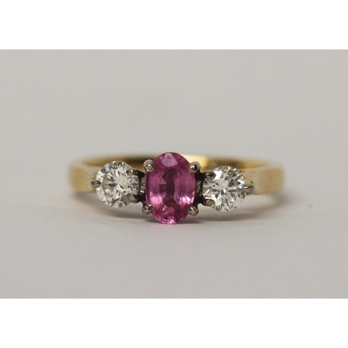 521 - 18ct gold three stone pink sapphire and diamond ring, hallmarked, ring size L, 3.7gms