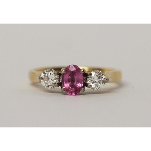 521 - 18ct gold three stone pink sapphire and diamond ring, hallmarked, ring size L, 3.7gms