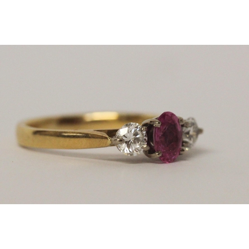 521 - 18ct gold three stone pink sapphire and diamond ring, hallmarked, ring size L, 3.7gms