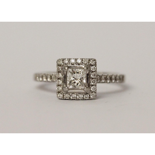 522 - A platinum and diamond engagement ring, central princess cut diamond surrounded by further diamonds ... 