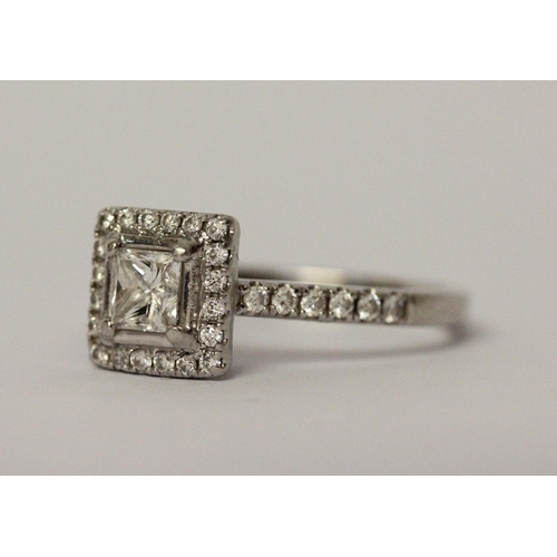 522 - A platinum and diamond engagement ring, central princess cut diamond surrounded by further diamonds ... 