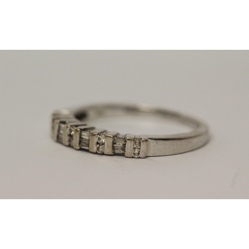 523 - 18ct white gold brilliant and baguette cut diamond half hoop ring, hallmarked, ring size M, 3.1gms