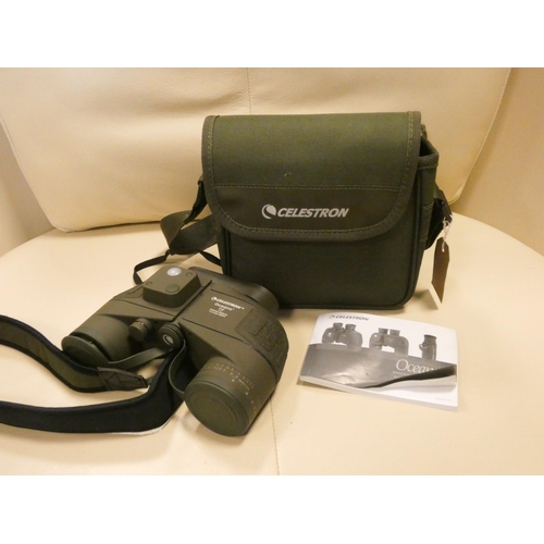 566 - A pair of Celestron Oceana binoculars and monocular with case and manual