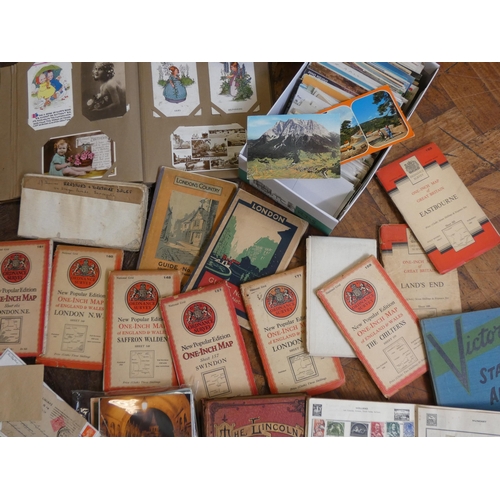 572 - A selection of assorted postcards, various London and other maps, three stamp albums etc, all contai... 