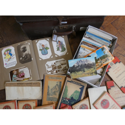 572 - A selection of assorted postcards, various London and other maps, three stamp albums etc, all contai... 