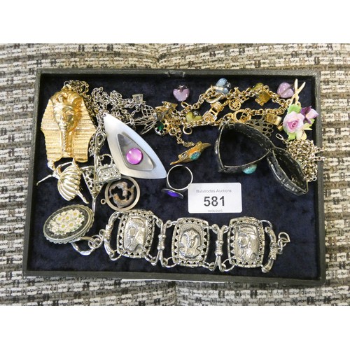 581 - A small selection of ladies costume jewellery to include brooches, charm bracelet, necklaces etc