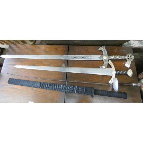 Two replica swords, a fencing foil and a Japanese sword in scabbard
