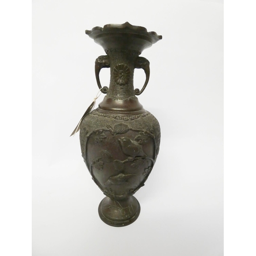 204 - A Japanese twin handled bronze vase decorated in relief with finches, 12