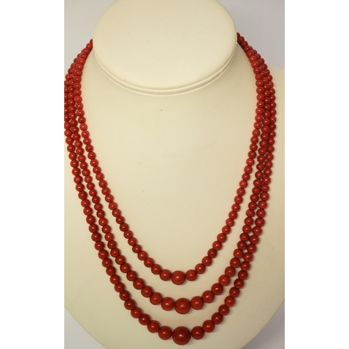 558 - Vintage red coral bead three strand necklace, with oval 18ct gold cabochon coral set clasp. With Gol... 