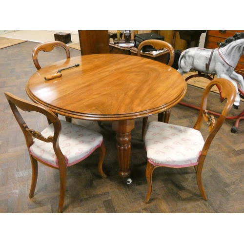 383 - A circular Victorian mahogany dining table with leaf and winder on reeded legs together with four Vi... 