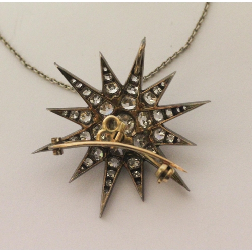 600 - A Victorian gold, silver and graduated old cut diamond set starburst pendant / brooch, with associat... 