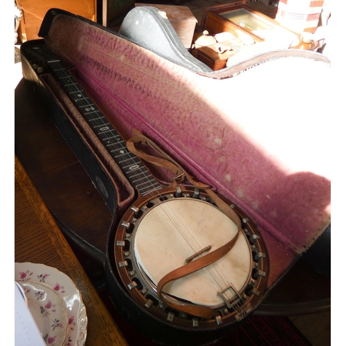 115 - A Banjo in case and a Violin (as found) in case