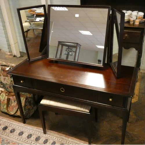 338 - A Stag minstrel mahogany dressing table fitted three drawers and triple mirrors with matching stool ... 