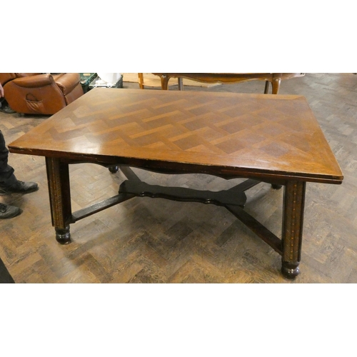 413 - A large French oak drawer leaf dining table with parquetry style top standing on a heavy cross stret... 