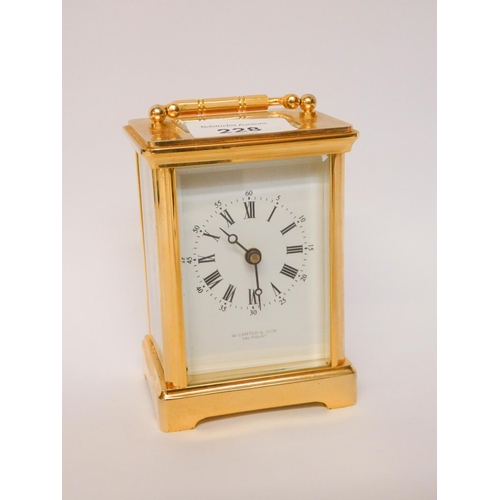 228 - A gilt brass carriage clock with white enamel dial signed W Carter & Son Salisbury