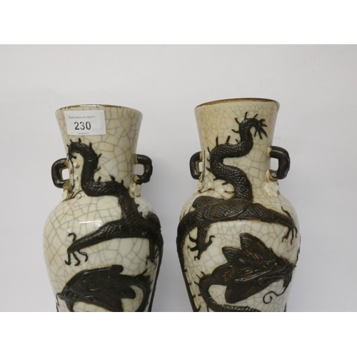 230 - A pair of Japanese crackle ware twin handled vases decorated in relief with a coiled dragon, seal ma... 