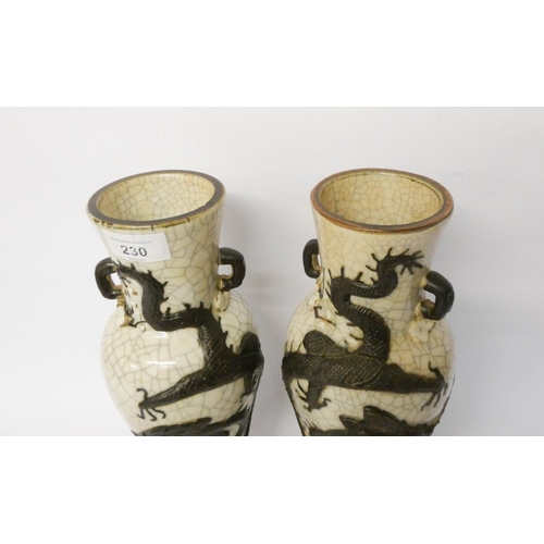 230 - A pair of Japanese crackle ware twin handled vases decorated in relief with a coiled dragon, seal ma... 