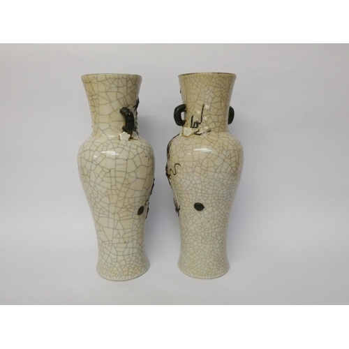 230 - A pair of Japanese crackle ware twin handled vases decorated in relief with a coiled dragon, seal ma... 