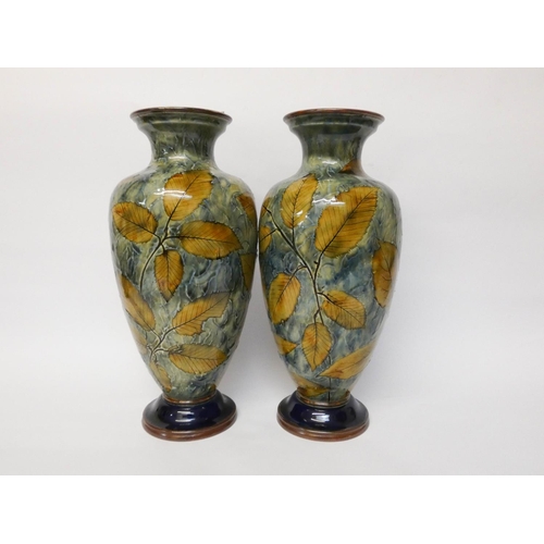 232 - A pair of Royal Doulton stoneware vases, decorated with leaves, number on the base BB36768, 32cms ta... 