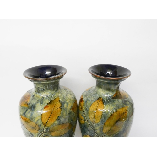 232 - A pair of Royal Doulton stoneware vases, decorated with leaves, number on the base BB36768, 32cms ta... 