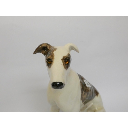 240 - A Winstanley pottery model of a seated lurcher or whippet with glass eyes, height 32cms