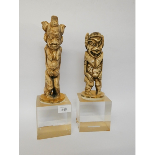 245 - A pair of carved bone tribal figures, later mounted on flexi-glass bases, height overall 35cms