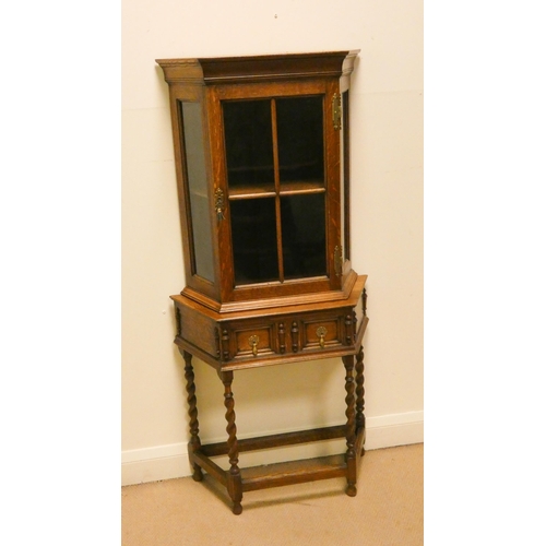 412 - A 1930's small oak glazed corner cabinet on a table style base, fitted drawer on barley twist legs, ... 