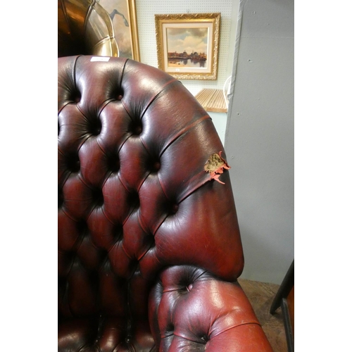 278 - A tub shaped red buttoned leather revolving office chair, unfortunately leather holed